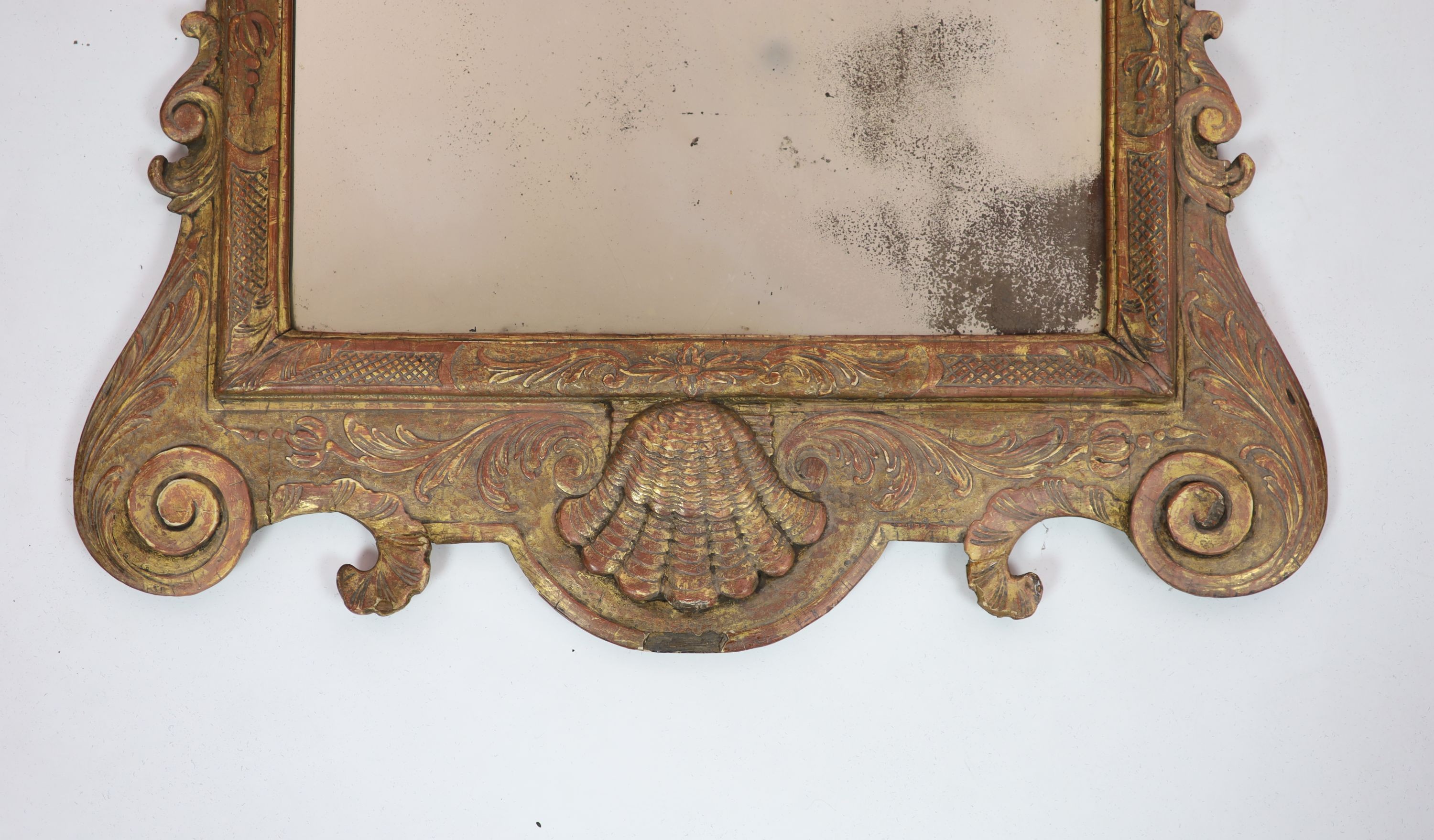 A George II giltwood and gesso wall mirror, of shaped form with contemporary rectangular plate H 111cm. W 59cm.